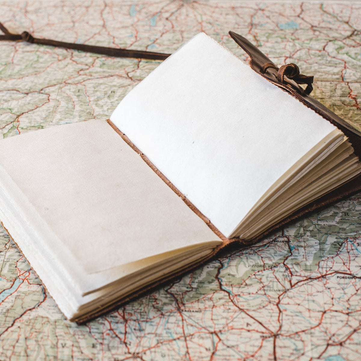 Open notebook resting on a map, ready for French lessons