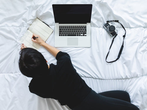 Learner studying with a notebook and laptop